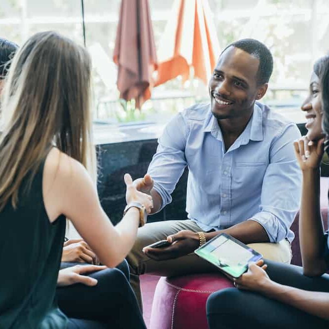 Business meeting in lobby of colorful modern office space